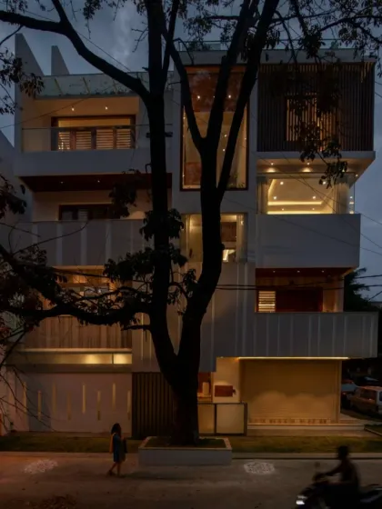 Where architecture captivates passersby and effortlessly coexists with the natural landscape. This home's facade is a composition of light-filled voids and solid planes, framed by a mature tree.