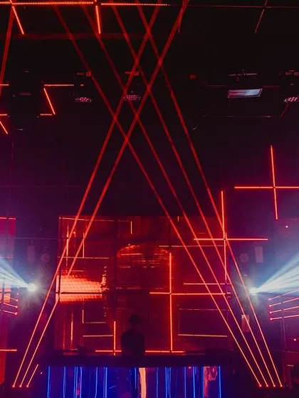 The main stage and DJ booth, featuring a massive grid of programmed laser lights and strobes. The light show was synchronized with the music to create an authentic techno club experience.