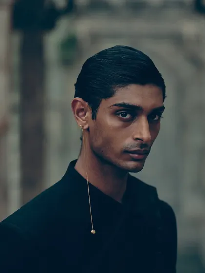 A minimalist portrait focusing on a single, delicate piece of jewelry. This shows my approach to accessorizing for men, which is often subtle but impactful.