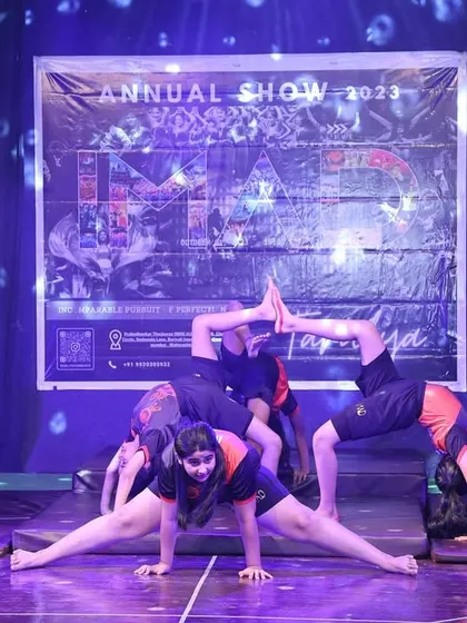 This intricate formation showcases incredible flexibility and strength. Our students perform advanced moves like splits and backbends as part of a cohesive and artistic group routine.