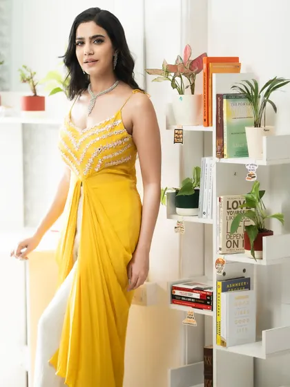 My work isn't just about lehengas. I love bringing my energy to chic Indo-Western outfits like this vibrant yellow ensemble. It shows my versatility and ability to model for brands that offer modern, festive fashion.