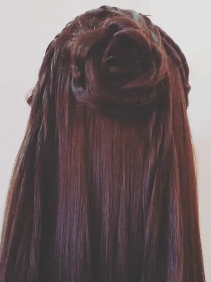 A simple half-up style where the top section of hair is styled into a neat rose bun. This keeps the hair tidy while allowing the rest to flow freely, combining the elegance of an updo with the beauty of open hair.