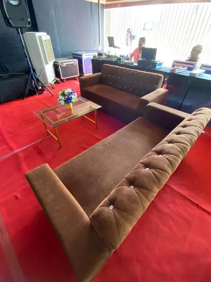 A comfortable lounge seating area being set up within a real estate exhibition. Providing these informal zones with sofas and coffee tables is a great way to facilitate longer conversations with potential clients in a relaxed setting.