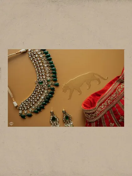The details matter. This flat lay showcases the bride's stunning Sabyasachi jewelry and a piece of her lehenga, highlighting the craftsmanship and personal style that make each wedding unique.