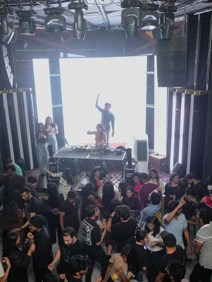A look at a full house from my console. I am experienced in playing for large crowds in multi-level clubs, ensuring the energy reaches every corner of the venue.