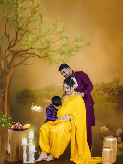 A beautiful family portrait in our Ravi Varma artistic style. The father and older brother lovingly interact with the baby bump, creating a timeless and painterly image.