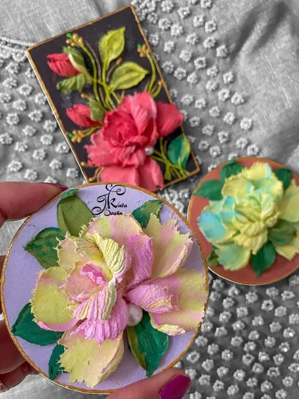 Another view of the three fridge magnets, highlighting the two-toned flowers.