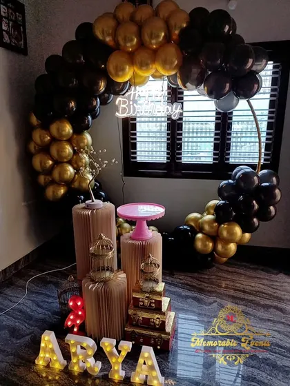 A chic black and gold birthday setup in a corner, showing how we can decorate even smaller spaces beautifully.
