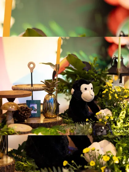 A plush monkey and golden pineapple sit among other jungle-themed elements, adding texture and richness to the overall decor.