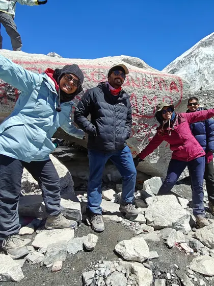 Fun and celebration at the famous Everest Base Camp rock. The camaraderie and shared joy among team members is a huge part of what makes our expeditions special.