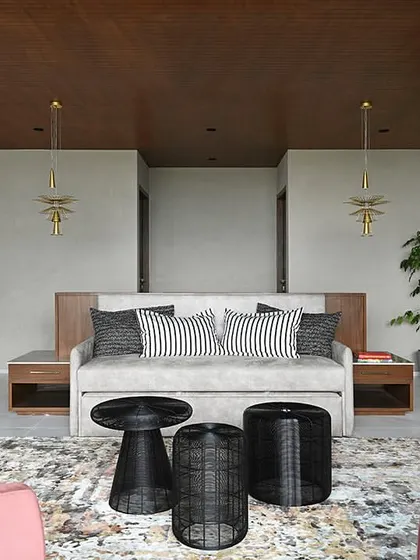 The ante-room designed with a comfortable sofa bed and stylish armchairs, providing a flexible space for relaxation or hosting guests in a less formal setting.