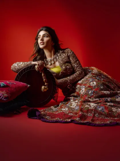 A dynamic pose with Sreeleela, showcasing the movement and flow of the embroidered lehenga. The styling was designed to be both photogenic and expressive, capturing a sense of joyful energy.