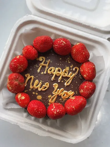 Happy New Year! A chocolate bento cake decorated with fresh strawberries and gold dust to ring in the new year.