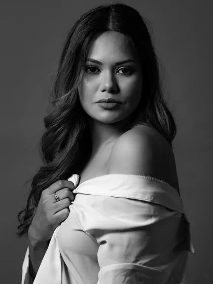 A classic beauty portrait in monochrome. The soft lighting beautifully sculpts the model's features, and the off-the-shoulder shirt adds a touch of relaxed elegance. This is timeless glamour.