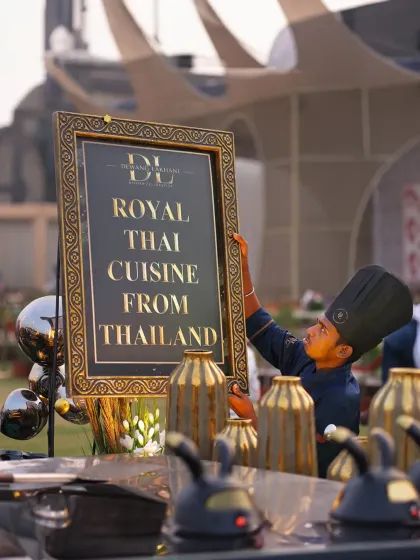 A sign announcing "Royal Thai Cuisine from Thailand" is set up by our team. We bring authentic international food experiences to our events, complete with dedicated, themed stations.