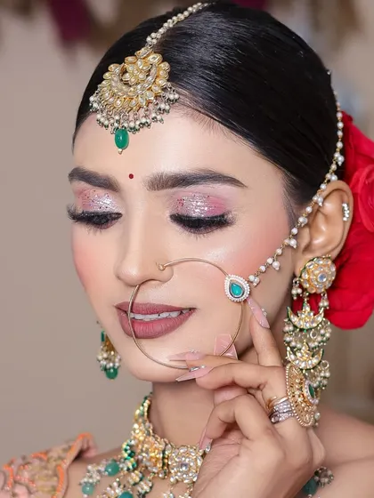 A close-up showing the flawless application of eyeshadow and liner by a student.