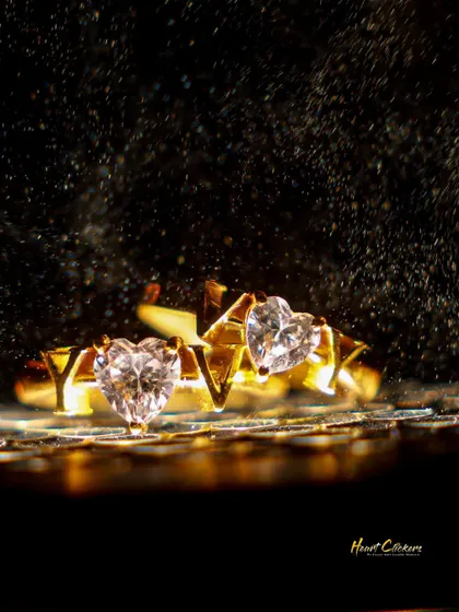 A stunning close-up of the couple's custom heart-shaped diamond rings, symbolizing their unique love.