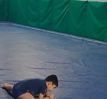 A quiet moment of focus during a flexibility drill. Even the simplest stretches require concentration and patience.