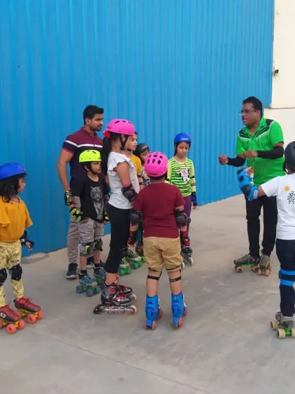 A young group of skaters listening to instructions before practice. I make sure every child is equipped with proper safety gear like helmets and knee pads before we start any session on the court.