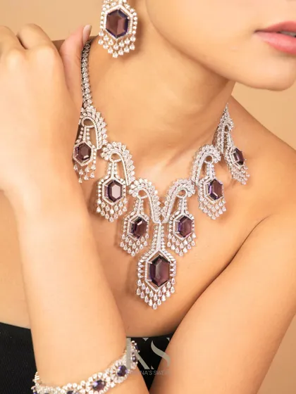 A full view of our diamond-look necklace with deep purple stones. This piece is perfect for a glamorous evening look.
