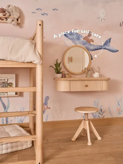 This little vanity area is her space for self-care. Having her own mirror and stool at her height encourages her to practice small routines independently.