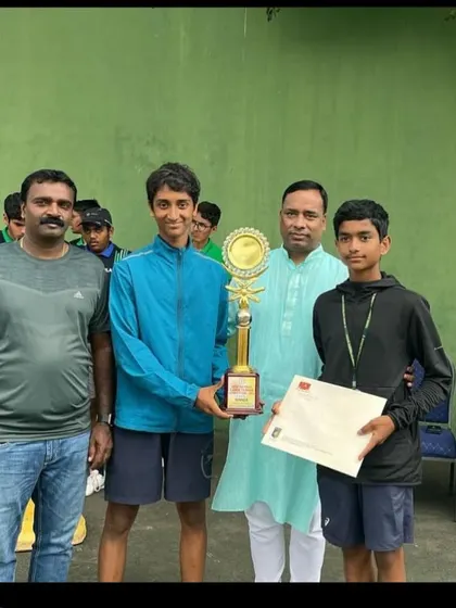 Harivansh and his partner receiving their doubles trophy, celebrating a successful tournament.