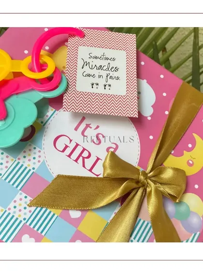 The top of the twins hamper, featuring a cute tag that reads 'Sometimes miracles come in pairs'.