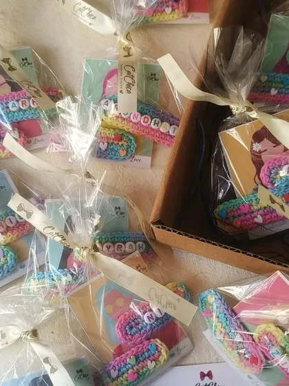 A box filled with individually wrapped name clip party favors, tied with our branded ribbon. We handle the packing so you don't have to.