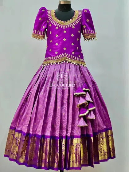 A rich purple Kanchi pattu lehenga. The blouse has delicate gold embroidery, and the skirt has a traditional gold border.