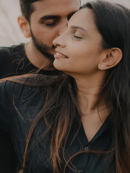 An intimate close-up that captures a tender moment. The focus on their faces and the soft light create a very personal and emotional portrait.