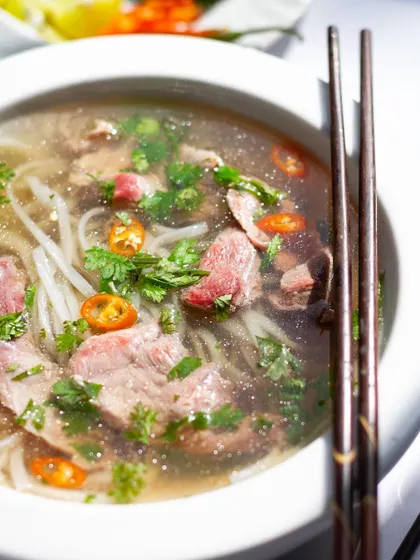A close-up of our Vietnamese Pho, showing the fresh herbs and chilies that give it its signature vibrant flavor.