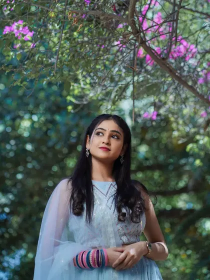 A portrait with the model looking up, surrounded by flowers. This creates a hopeful and romantic mood.