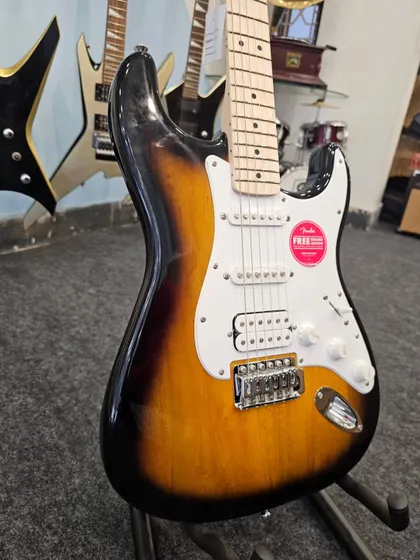 A side profile of the Fender FSR Stratocaster HSS in 2-Tone Sunburst. This angle highlights the classic Strat body contours and the versatile HSS pickup configuration, combining single-coil clarity with humbucker power.