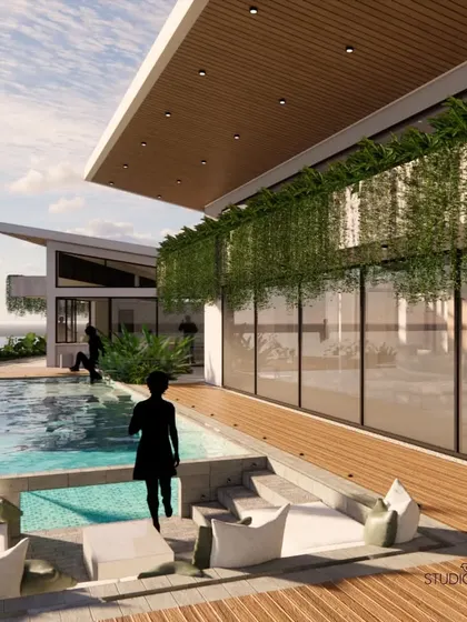 The sunken seating area is a key feature of the pool deck, creating an intimate conversation pit that is level with the water. This design allows for a unique, immersive experience of being surrounded by the pool.