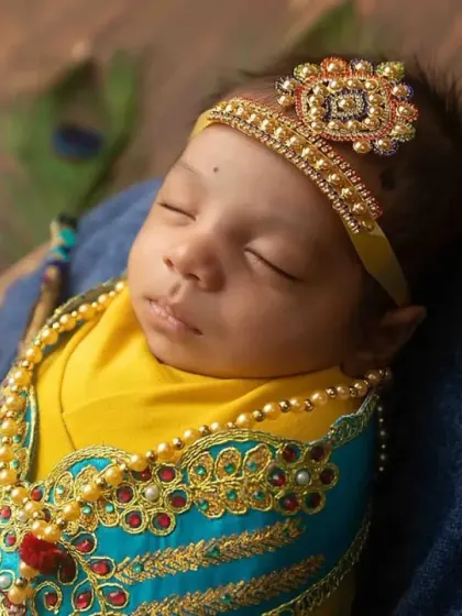 A close-up of our little Krishna, showing the intricate details of the costume and the peaceful expression on his face.
