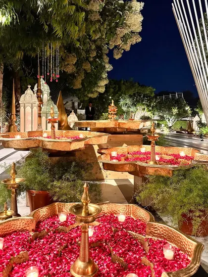 A multi-tiered water feature with floating candles and rose petals, creating a stunning entrance piece.
