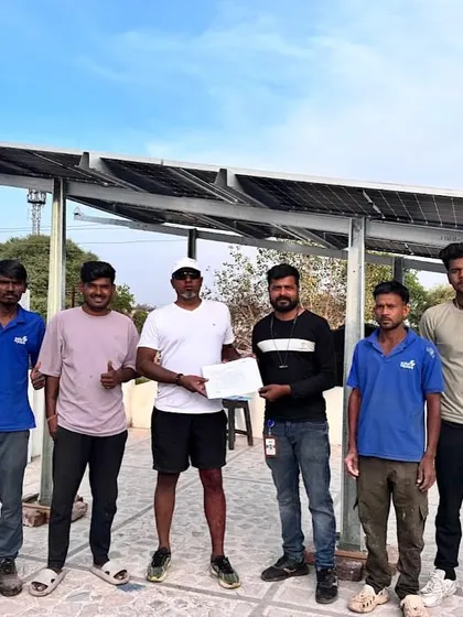 A customer and our team proudly stand beside a newly installed solar system, ready to harness the power of the sun.