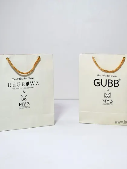 We can create custom paper bags for multiple brands, as shown here with bags for Regrowz and Gubb. Consistent quality and design ensure a professional presentation for any event.