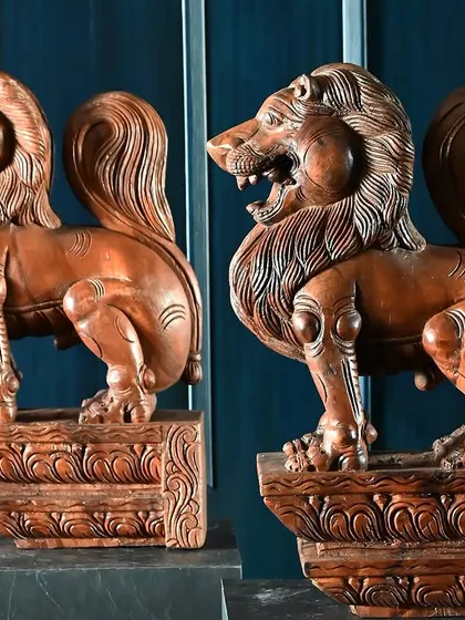 A pair of majestic wooden lions, hand-carved with incredible detail. These figures, often seen as guardians in traditional architecture, were part of our Navaratri celebration, showcasing the power and artistry of our collection.