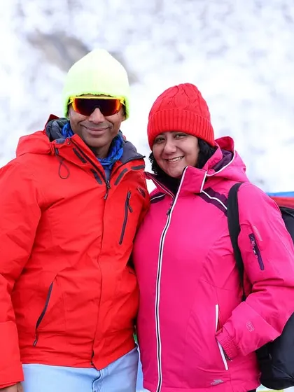 A close-up of a couple enjoying the chilly weather at Khardungla Pass, bundled up in warm gear.