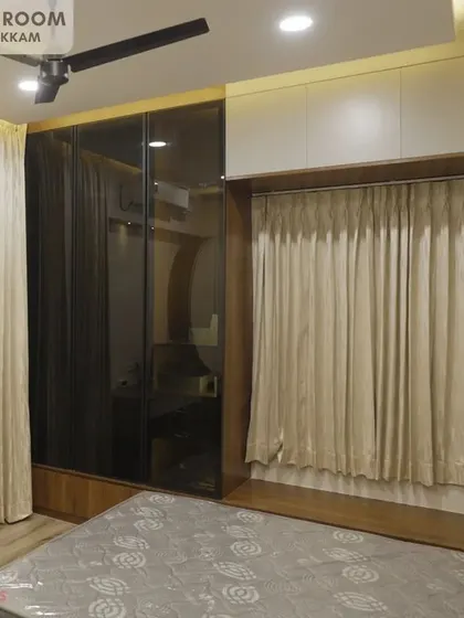 The daughter's bedroom in the Ayyapakkam villa, featuring a unique design with a foldable bed concealed by curtains and a sleek, dark-tinted glass wardrobe.