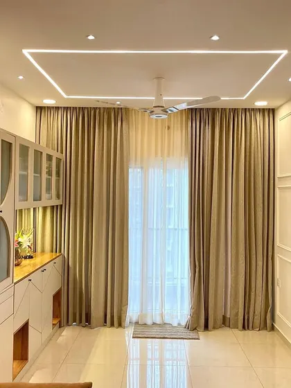 The dining area is defined by classic white wall molding and elegant, full-length curtains. The design creates a sophisticated backdrop that feels both timeless and contemporary.