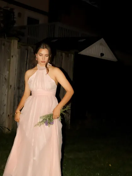 A candid-style photo in the pink Jardinvue dress, showing its movement and texture.