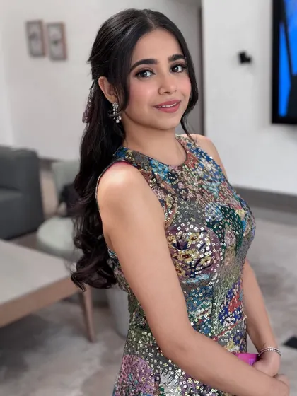 A smiling shot with a cute and stylish half-up look.