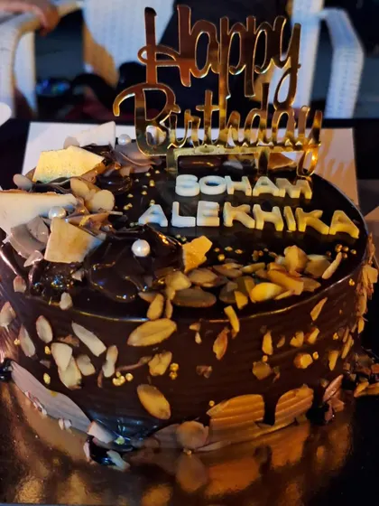 A rich chocolate almond cake made for a special 10th birthday. This cake is covered in chocolate ganache and loaded with toasted almonds for a wonderful crunch.
