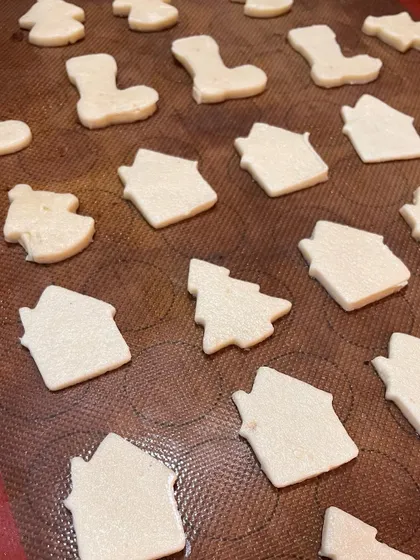 Little snippets of our Christmas baking, with sugar cookies cut into festive shapes like houses, trees, and stockings.