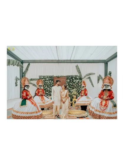 A wedding that blends traditions. This unique shot features the couple posing with Kathakali dancers, adding a vibrant and cultural element to their Pushkar wedding album.
