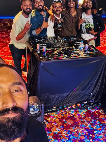 A selfie with the crew after a show, with the DJ booth and confetti-strewn floor in full view.