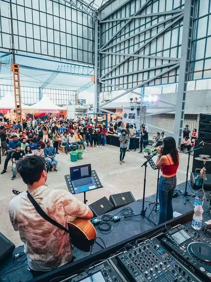 A wide shot from a performance at a cool industrial-style venue. No matter the size of the stage, connecting with the audience is always my goal.