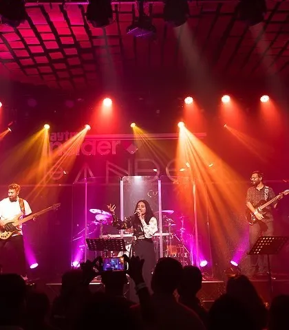 On stage with my full band, under the vibrant lights. This is the setup we bring to give you an unforgettable live music experience.